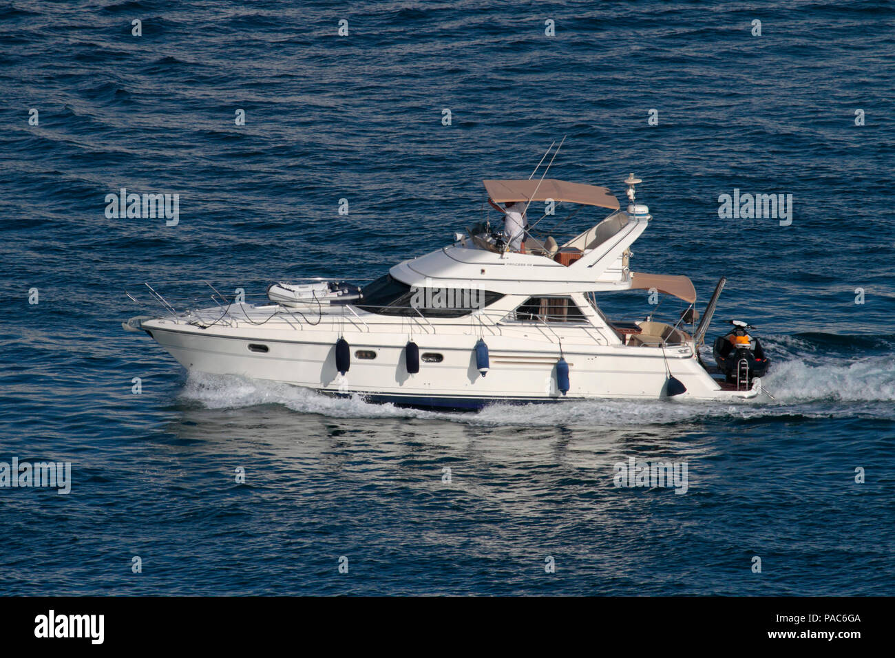 Princess 410 motor yacht with dinghy fore and jetski aft Stock Photo