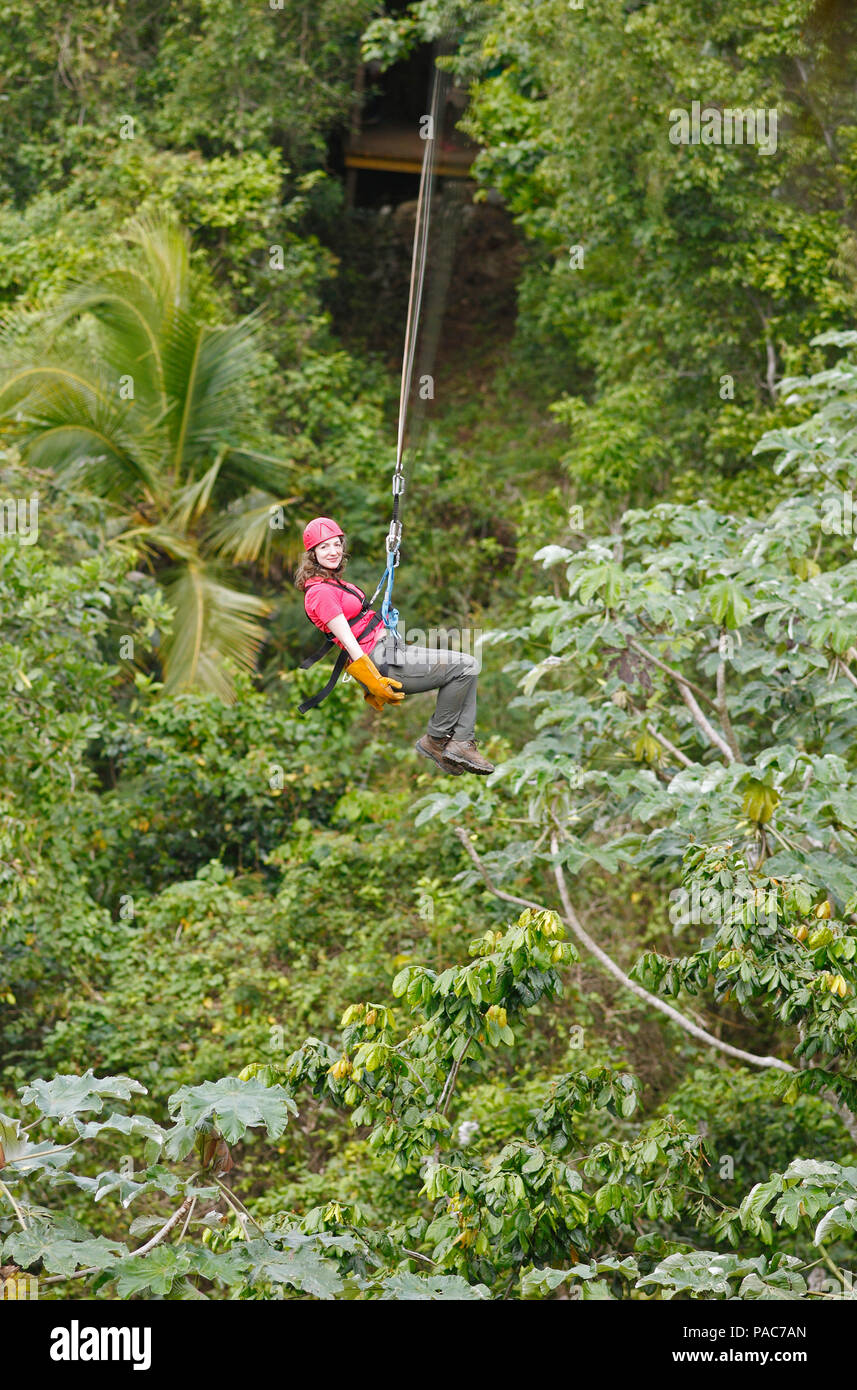 Woman, 38, riding a zipline through the jungle, Samaná province ...