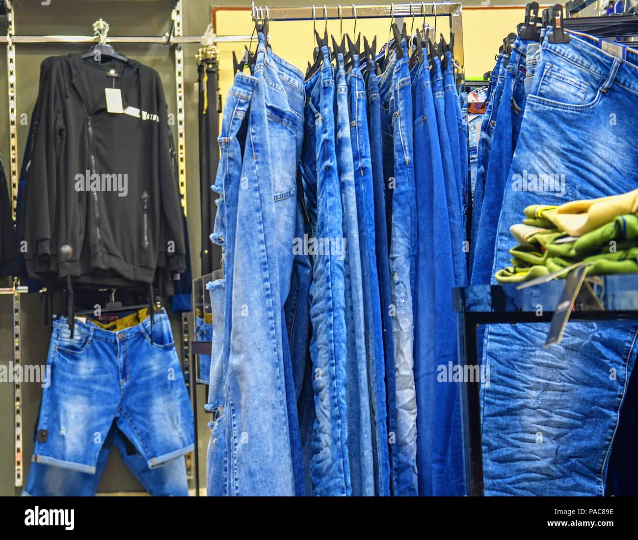 Premium Photo  A row of hangers with cheap pants in the store in