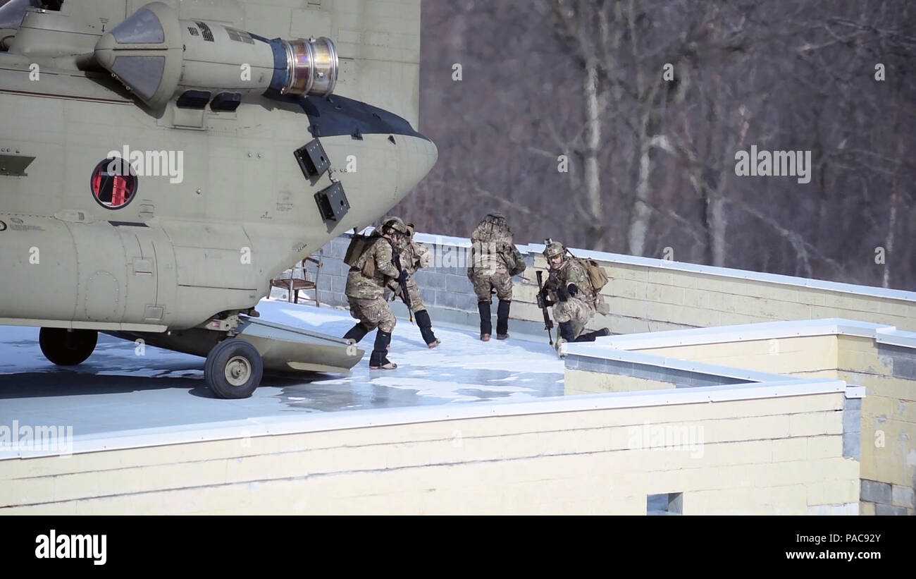 Members of the New York Air National Guard's 274th Air Support Operations Squadron (ASOS) disembark from a CH-47F helicopter flown by the New York Army National Guard's Company B, 3rd Battalion 126th Aviation, onto a rooftop LZ at Fort Drum, N.Y.'s urban training site during joint training   on Saturday, March 5, 2016. The 274th mission is to advise U.S. Army commanders on how to best utilize U.S. and NATO assets for Close Air Support. The CH-47 aircrew supported the joint terminal attack controllers of the 274th in an air insertion exercise in an urban environment. (U.S. Air National Guard ph Stock Photo