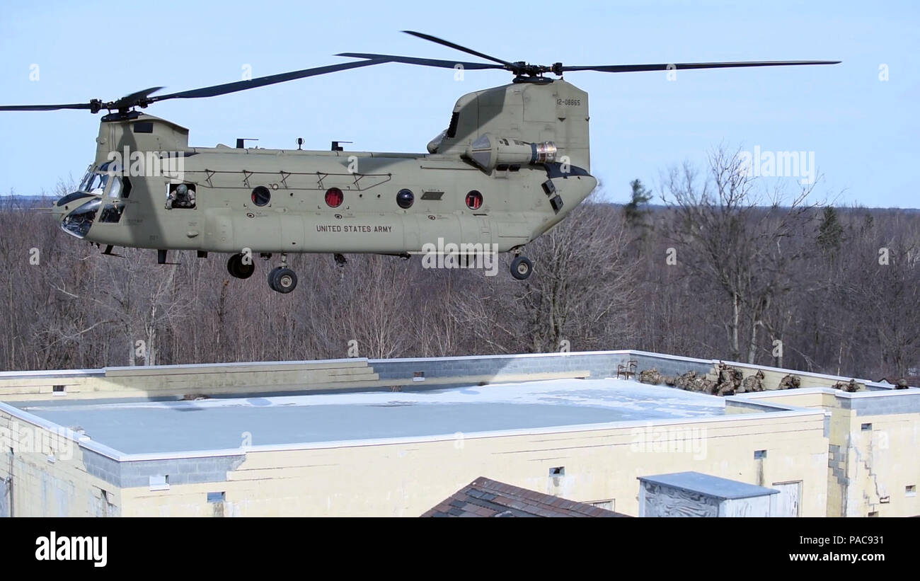 A CH-47F helicopter  flown by the New York Army National Guard's Company B, 3rd Battalion 126th Aviation, leaves a rooftop LZ at Fort Drum, N.Y.'s urban training site during joint training with the New York Air National Guard's  274th Air Support Operations Squadron (ASOS)  on Saturday, March 5, 2016. The 274th mission is to advise U.S. Army commanders on how to best utilize U.S. and NATO assets for Close Air Support. The CH-47 aircrew supported the joint terminal attack controllers of the 274th in an air insertion exercise in an urban environment. (U.S. Air National Guard photo by Master Sgt. Stock Photo