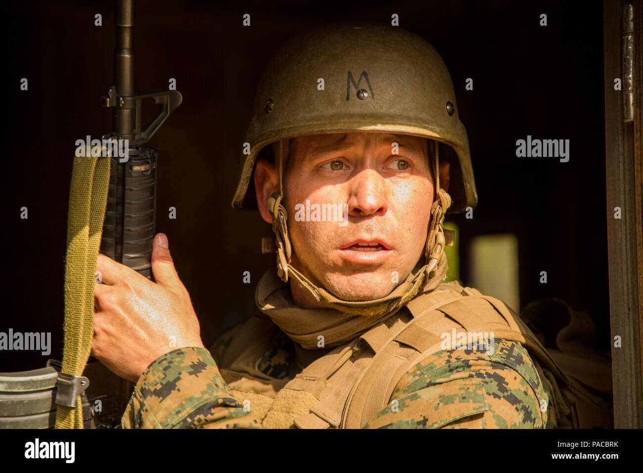 A U.S. Navy Corpsman assigned to Field Medical Training Battalion East (FMTB-E), searches for opposing forces during a final exercise (FINEX) at Camp Johnson, N.C., March 1, 2016. FINEX is a culminating event at FMTB-E which transitions Sailors into the Fleet Marine Force. (U.S. Marine Corps photo by Sgt. James R. Skelton/Released) Stock Photo