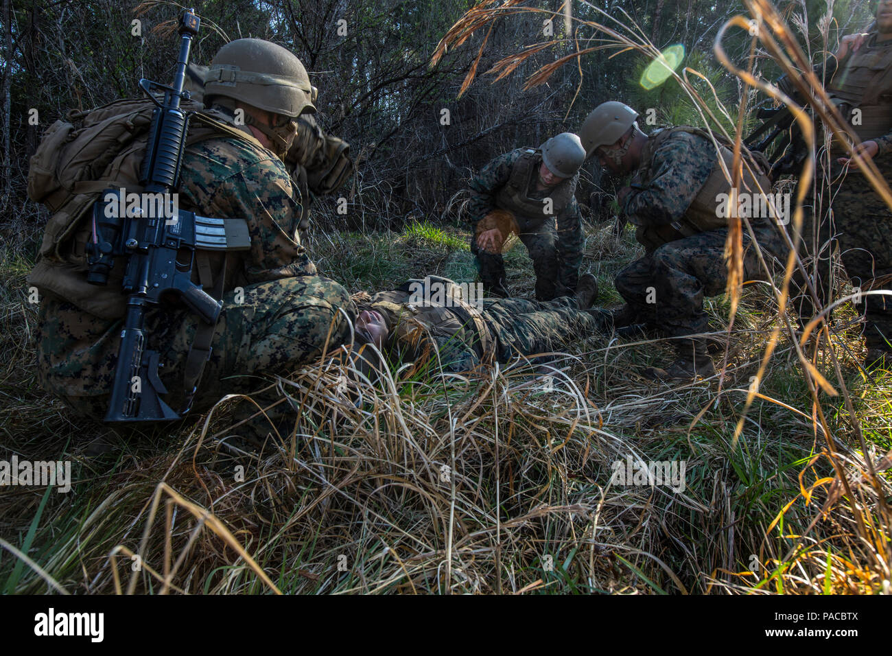U.S. Navy Corpsmen assigned to Field Medical Training Battalion East (FMTB-E), treats a simulated casualty during a final exercise (FINEX) at Camp Johnson, N.C., March 2, 2016. FINEX is a culminating event at FMTB-E which transitions Sailors into the Fleet Marine Force. (U.S. Marine Corps photo by Sgt. James R. Skelton/Released) Stock Photo