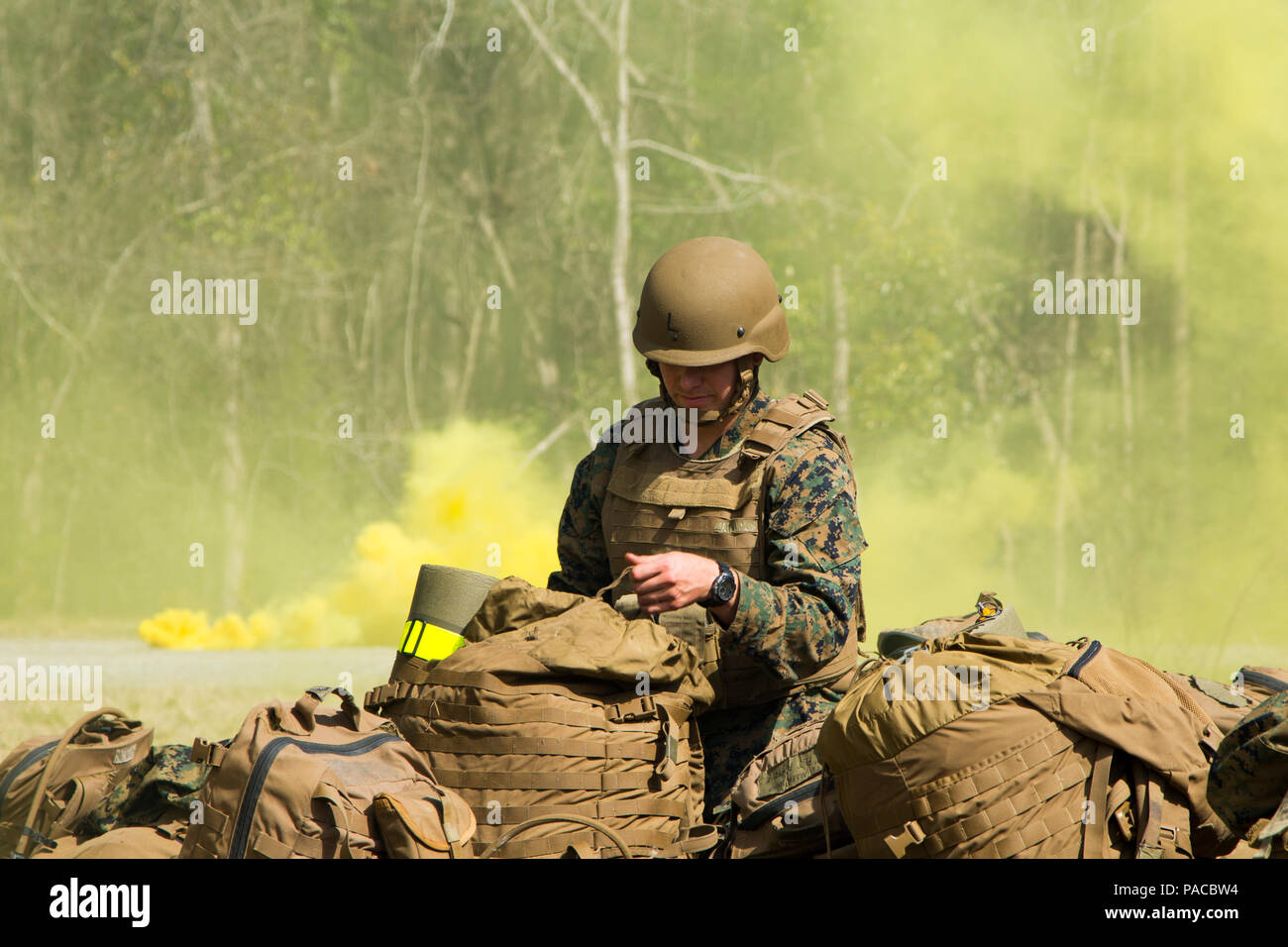 A U.S. Navy Corpsman assigned to Field Medical Training Battalion East (FMTB-E), adjusts his gear during a final exercise (FINEX) at Camp Johnson, N.C., March 2, 2016. FINEX is a culminating event at FMTB-E which transitions Sailors into the Fleet Marine Force. (U.S. Marine Corps photo by Sgt. James R. Skelton/Released) Stock Photo