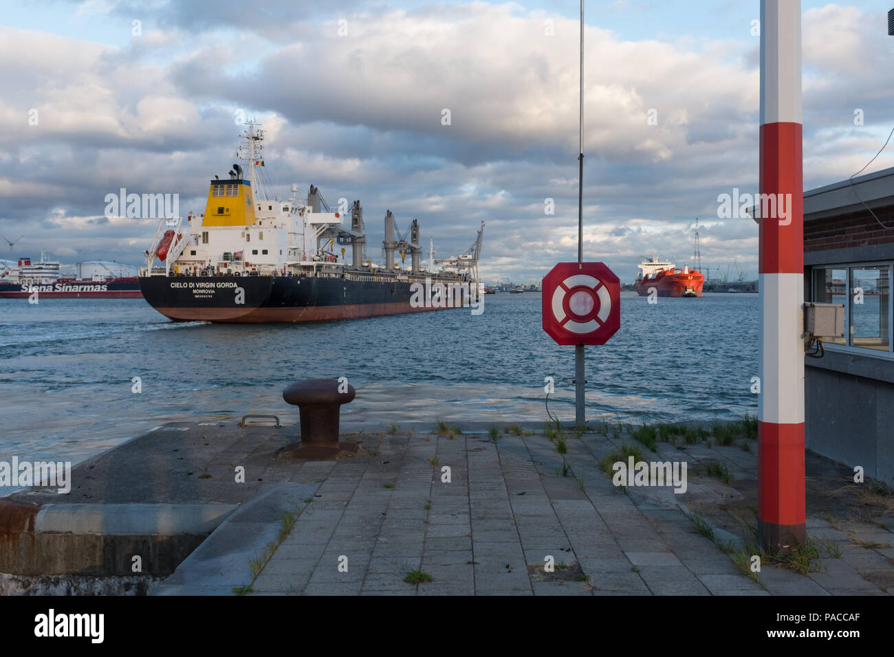 Bulk Carrier sailing out of the lock 'Boudewijnsluis', in the port of Antwerp, Belgium. Stock Photo