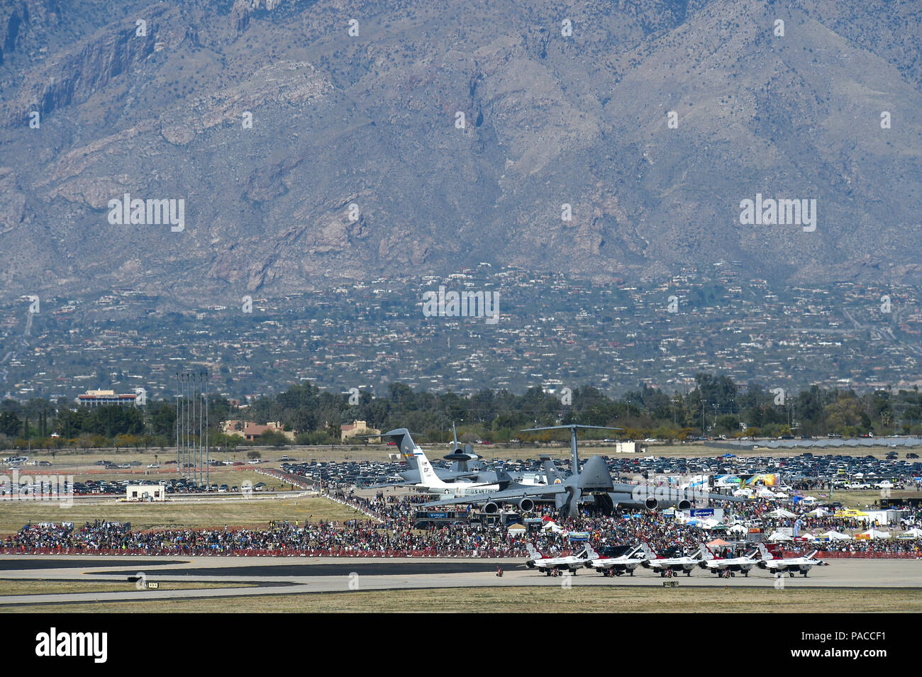 Thousands of attendees gather to watch aerial demonstrations and look at static displays on the flightline during the Thunder and Lightning over Arizona Open House at Davis-Monthan Air Force Base, Ariz., March 12, 2016.  The base opened its doors for the free event to showcase military air power and express appreciation for the local community's continuous support of D-M's missions. (U.S. Air Force photo by Senior Airman Chris Massey/Released) Stock Photo