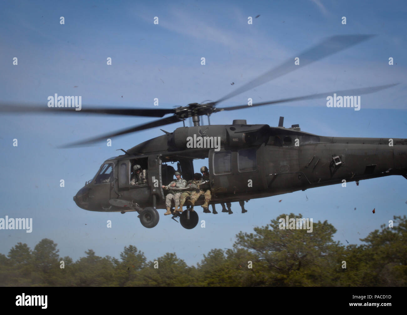 A New Jersey Army National Guard Black Hawk lifts off with U.S. Army Reserve paratroopers for a helicopter-borne parachute jump at Coyle Drop Zone, Joint Base McGuire-Dix-Lakehurst, N.J., March 12, 2016. (U.S. Air National Guard photo by Tech. Sgt. Matt Hecht/Released) Stock Photo