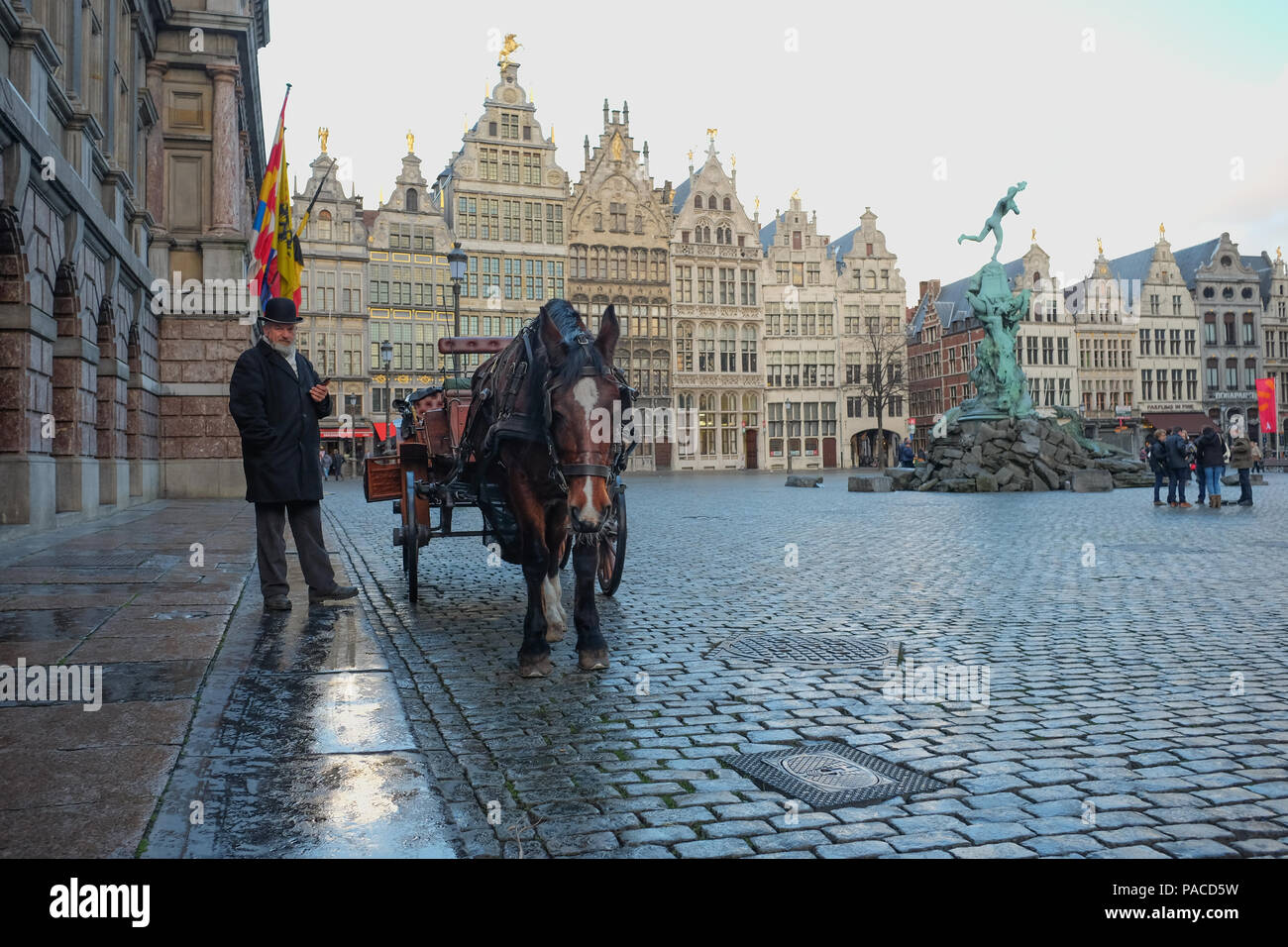 Man with cart and horse on historic 'Grote Markt' square in Antwerp, Belgium. Stock Photo