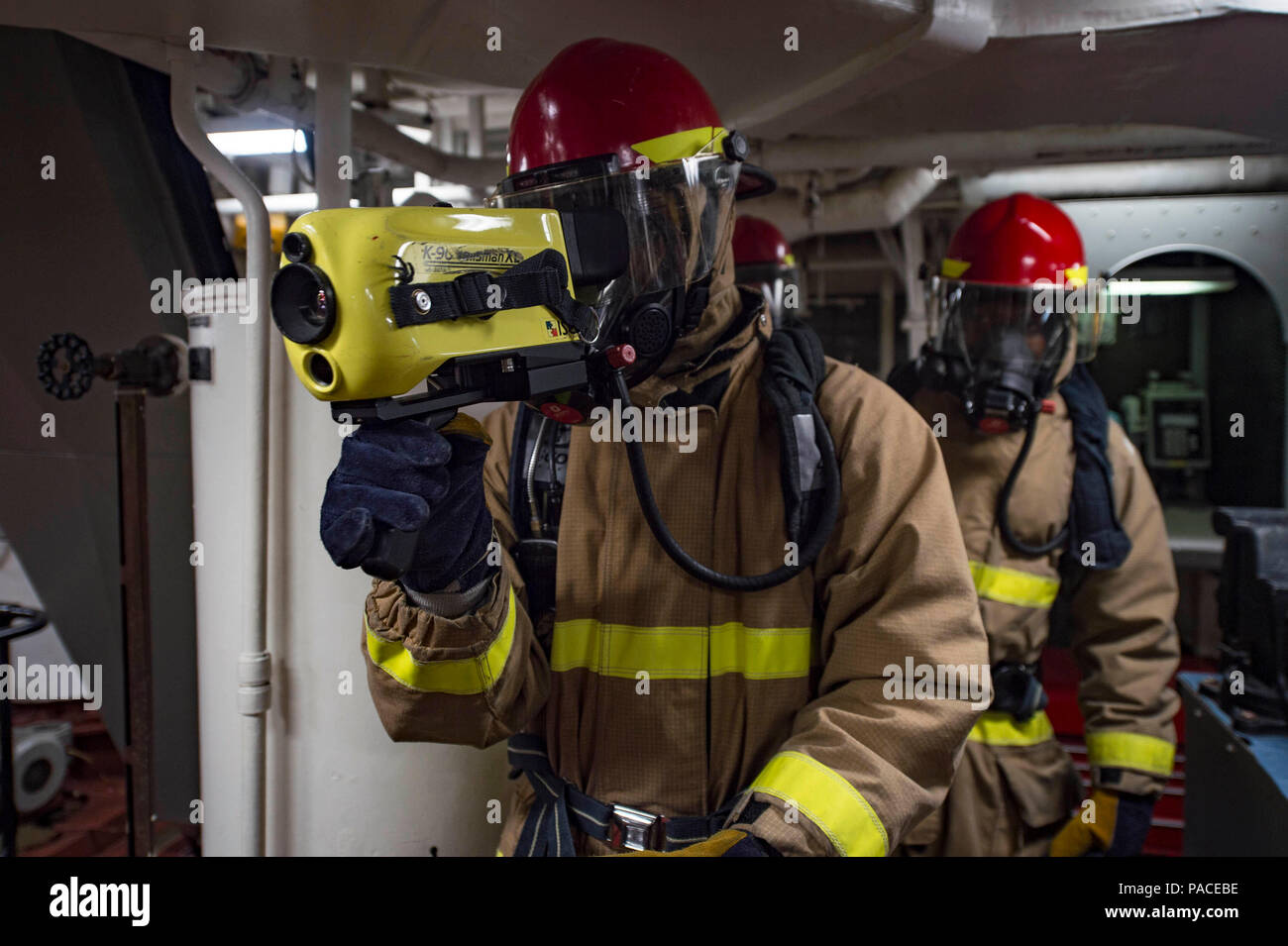 160311-N-MD297-132 PACIFIC OCEAN (March 11, 2016) - Damage Controlman Fireman Donte McNeil uses a Naval Firefighting Thermal Imager (NFTI) during a main space fire drill aboard the Arleigh Burke-class guided-missile destroyer USS Lassen (DDG 82). Lassen is deployed to the U.S. 4th Fleet area of responsibility supporting law enforcement operations as part of Operation Martillo. (U.S. Navy photo by Mass Communication Specialist 2nd Class Huey D. Younger Jr./Released) Stock Photo