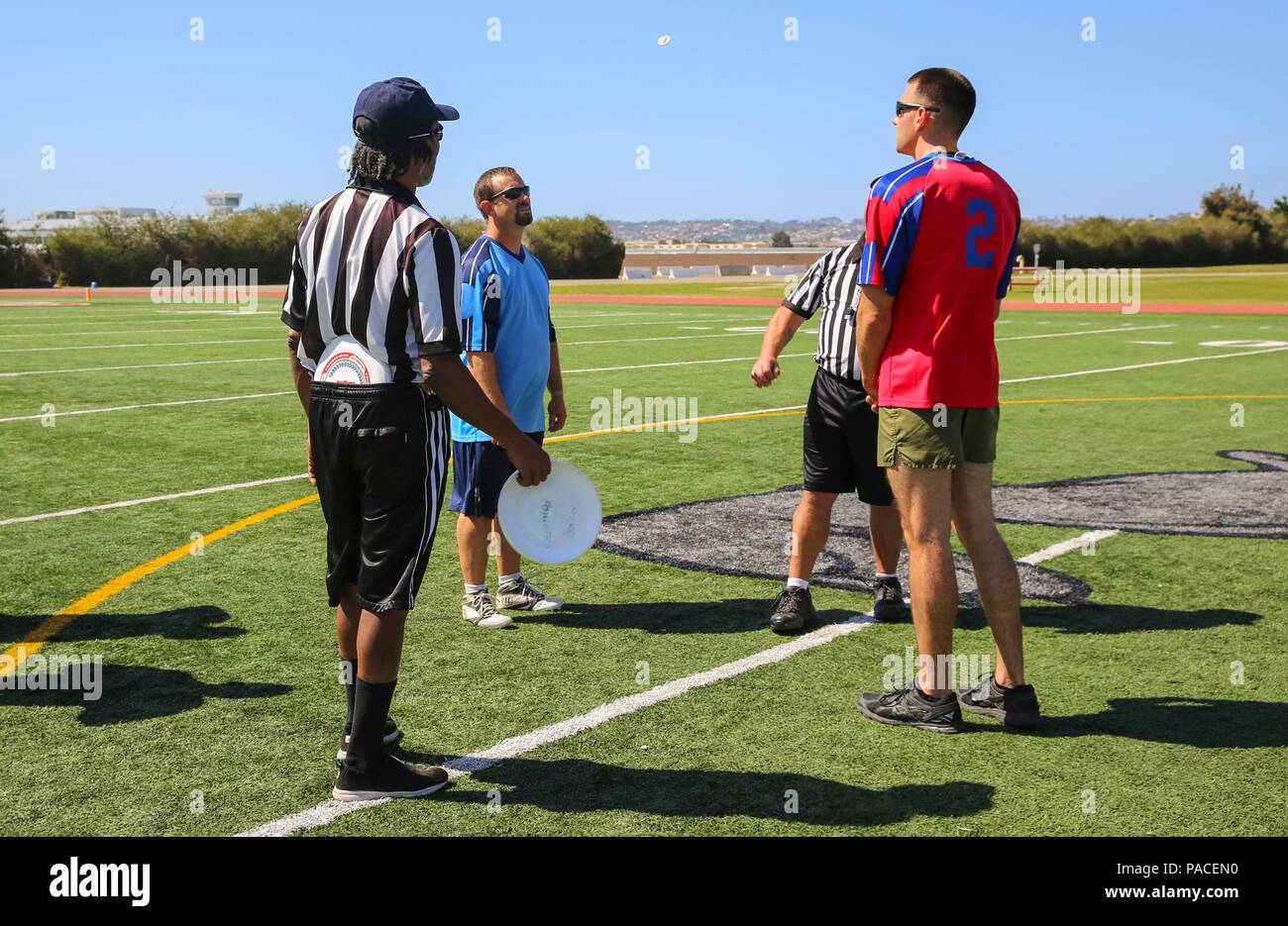 Team captains in the Commanding General’s Cup Ultimate Frisbee Tournament participate in a coin toss at the track and field area on Marine Corps Recruit Depot San Diego, March 15. Each match started with a coin toss to see who would have the Frisbee first. The CG’s Cup holds several sports tournaments throughout the year including volleyball and basketball. Stock Photo