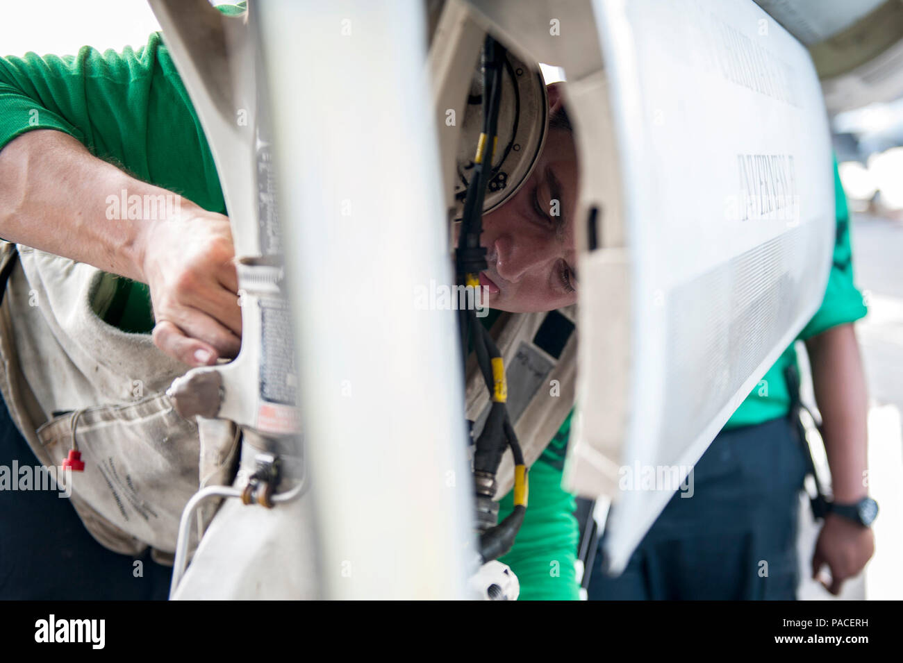 160311-N-MQ094-060 ARABIAN GULF (March 11, 2016) Aviation Electrician's Mate 1st Class Richard Gallon, assigned to the “Jolly Rogers” of Strike Fighter Squadron (VFA) 103, installs a cotter pin in the nose wheel of an F/A-18F Super Hornet on the flight deck of aircraft carrier USS Harry S. Truman (CVN 75). Harry S. Truman Carrier Strike Group is deployed in support of Operation Inherent Resolve, maritime security operations, and theater security cooperation efforts in the U.S. 5th Fleet area of operations. (U.S. Navy photo by Mass Communication Specialist 2nd Class Ethan T. Miller/Released) Stock Photo