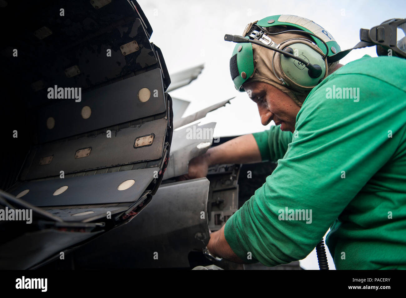 160311-N-MQ094-100 ARABIAN GULF (March 11, 2016) Aviation Machinist's Mate 1st Class Joel Perez, assigned to the “Jolly Rogers” of Strike Fighter Squadron (VFA) 103, conducts maintenance on an F/A-18F Super Hornet on the flight deck of aircraft carrier USS Harry S. Truman (CVN 75). Harry S. Truman Carrier Strike Group is deployed in support of Operation Inherent Resolve, maritime security operations, and theater security cooperation efforts in the U.S. 5th Fleet area of operations. (U.S. Navy photo by Mass Communication Specialist 2nd Class Ethan T. Miller/Released) Stock Photo