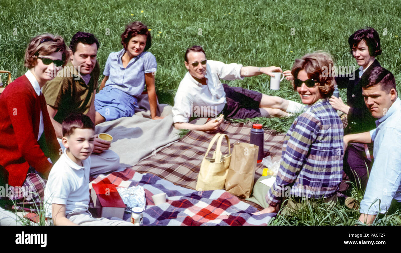 Group of expats having a picnic on a picnic rug in Hamburg, Germany in