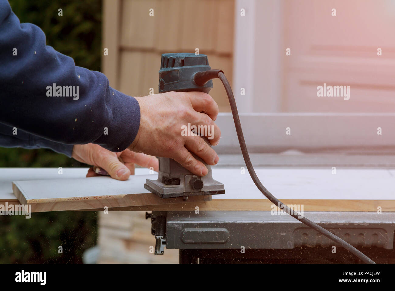 Processing of carpenter with Electronic Plunge Router wooden boards