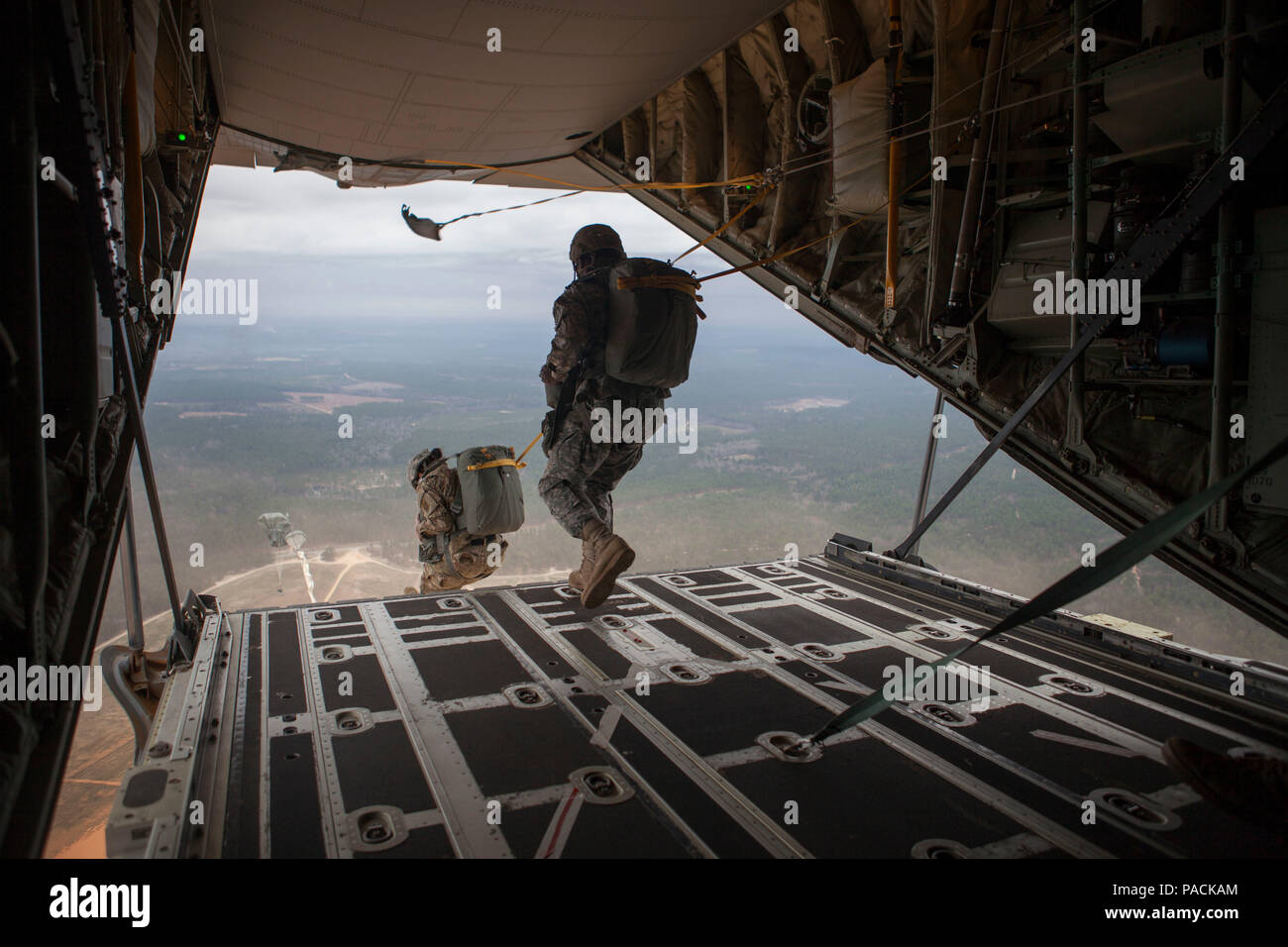 U.S. Army paratroopers execute a ramp jump from the tailgate of a C-130 ...