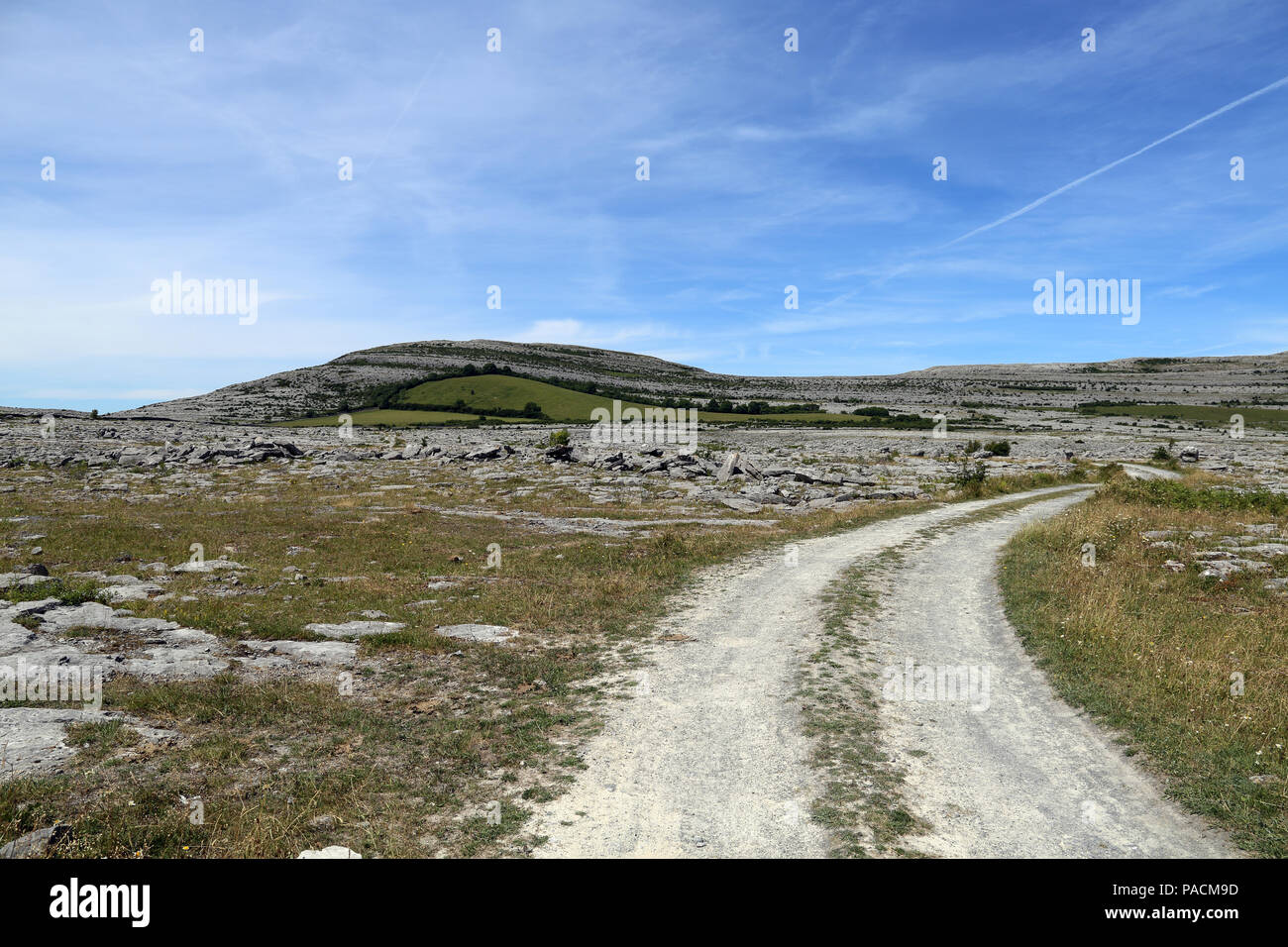 A road leads into the Burren. The Burren  'great rock'  is a region of environmental interest primarily located in northwestern County Clare, Ireland, Stock Photo