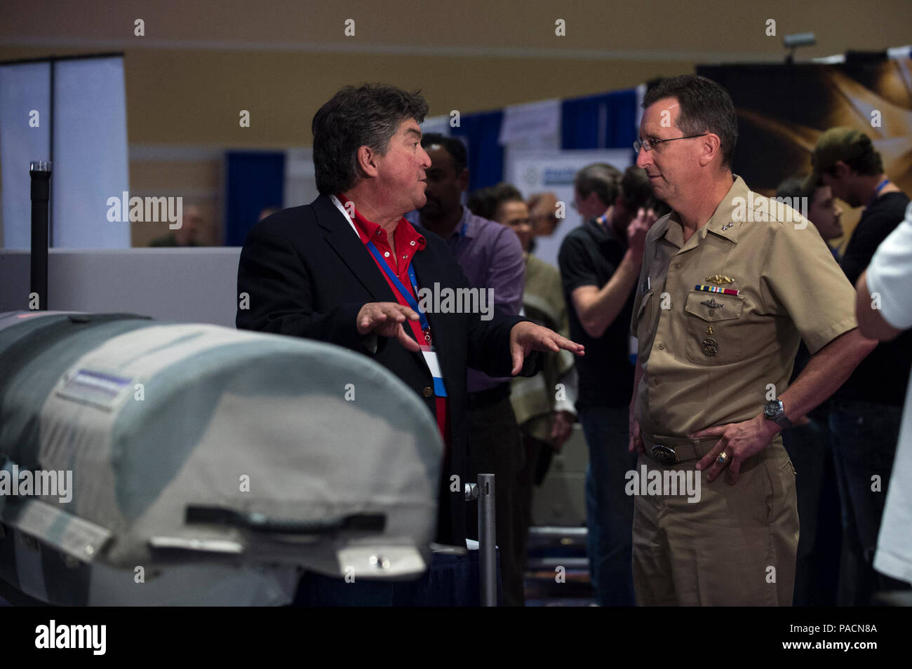 NATIONAL HARBOR, Md. (Apr. 2, 2017) Rear Adm. David Hahn, chief of naval research, talks to Anthony Mulligan, founder and CEO, Hydronalix, Inc., about the Emergency Integrated Lifesaving Lanyard (EMILY), a robotic device used by lifeguards for rescuing swimmers, prior to the opening of the Department of the Navy Forum for Small Business Innovation Research/Small Business Technology Transfer (SBIR/STTR) Transition. The forum is a long-standing venue for connecting SBIR/STTR-funded technologies with warfighters, government acquisition and technical personnel, large primes, system integrators, an Stock Photo