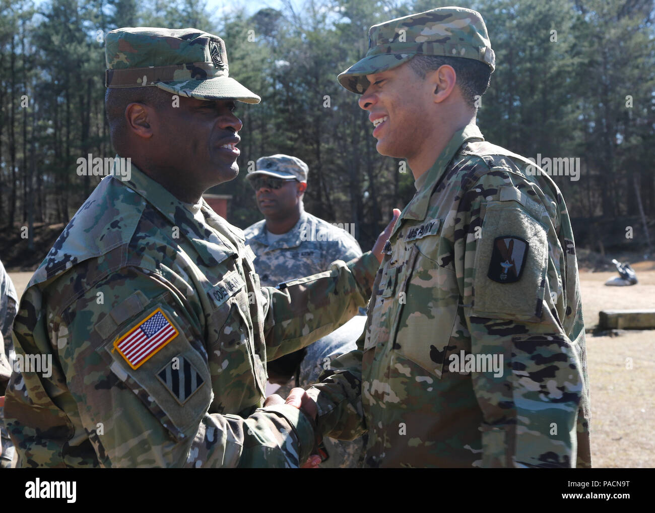 U.S. Army Command Sgt. Maj. Timothy Coleman, assigned to 114th Signal Battalion, congratulates Sgt. Samuel Nobles following his promotion at Fort George G. Meade, Md., March 2, 2016. The promotion from Specialist to Sergeant marks the responsibility instilled into the new noncommissioned officer. (U.S. Army photo by Spc. Alyssa Madero/Released) Stock Photo