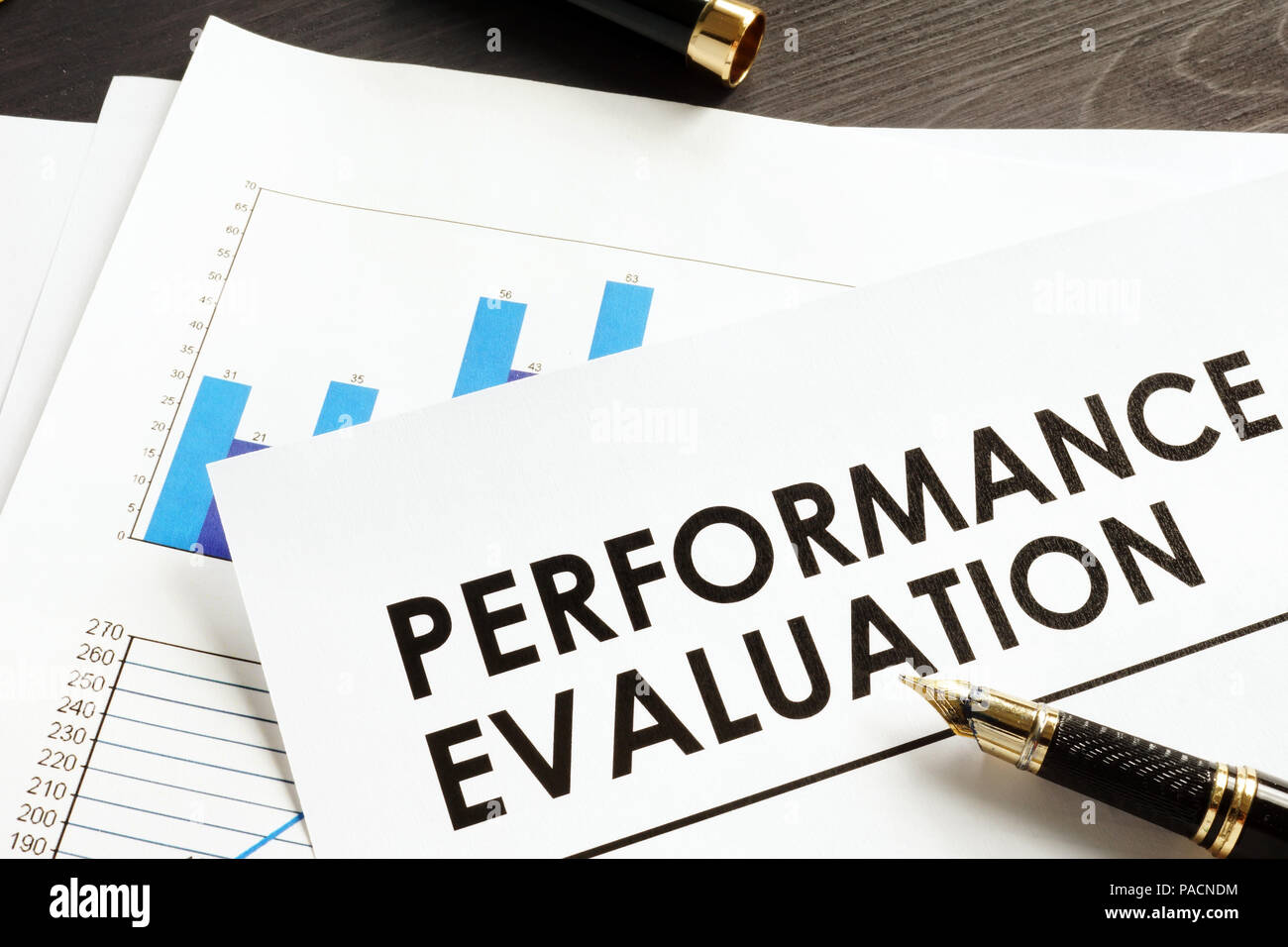 Documents about performance evaluation on a desk Stock Photo Alamy