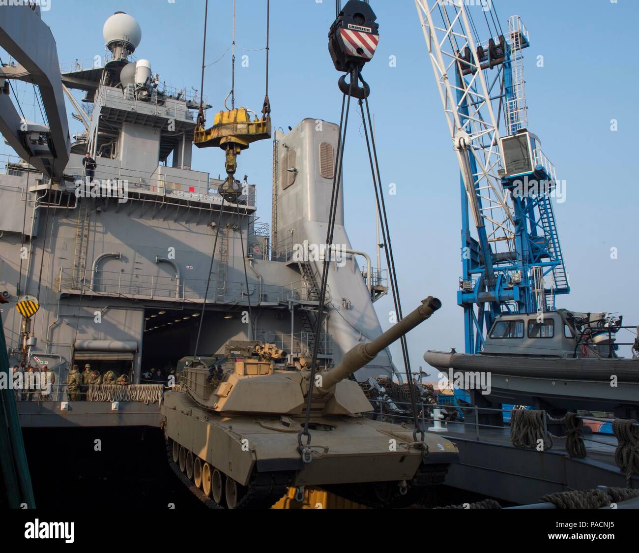 160314-N-RM689-008  GWANGYANG, Republic of Korea (Mar. 14, 2016)- An M1A1 Abram tank attached to Delta Company 1st Tank Battalion, 1st U.S. Marine Division is lowered by two pier side cranes into the well deck of amphibious dock landing ship USS Ashland (LSD 48) to prepare for the Assault Follow-On Echelon (AFOE) portion of Ssang Yong 16. Ashland is assigned to the Bonhomme Richard Expeditionary Strike Group and is participating in Ssang Yong 16, a biennial combined amphibious exercise conducted by forward-deployed U.S. forces with the Republic of Korea Navy and Marine Corps, Australian Army a Stock Photo