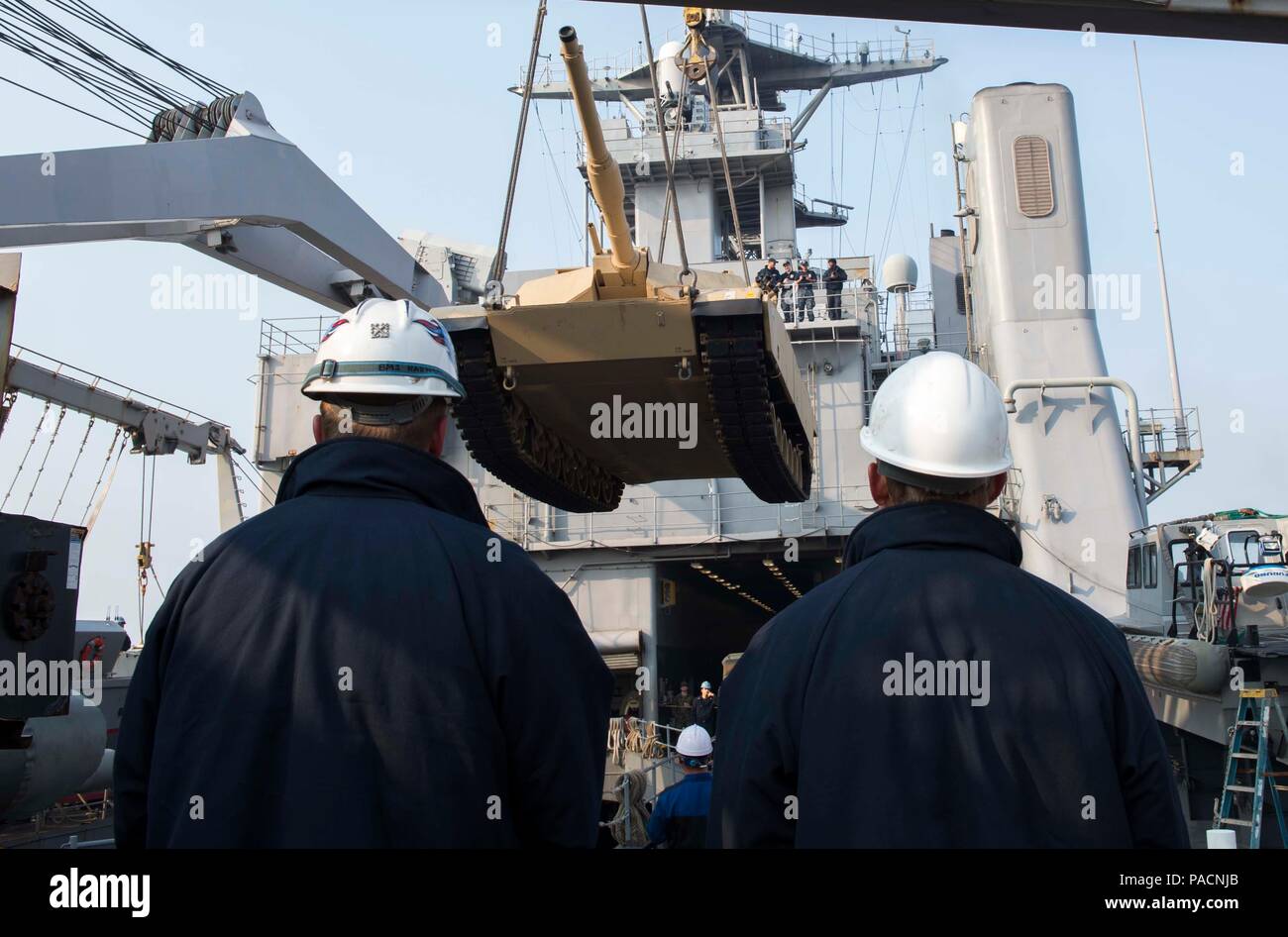 160314-N-RM689-066  GWANGYANG, Republic of Korea (Mar. 14, 2016)- Two Sailors from amphibious dock landing ship USS Ashland (LSD 48) act as safety officers on the boat deck as an M1A1 Abram tank attached to Delta Company 1st Tank Battalion, 1st U.S. Marine Division is lowered by two pier side cranes into the well deck of Ashland to prepare for the Assault Follow-On Echelon (AFOE) portion of Ssang Yong 16. Ashland is assigned to the Bonhomme Richard Expeditionary Strike Group and is participating in Ssang Yong 16, a biennial combined amphibious exercise conducted by forward-deployed U.S. forces Stock Photo