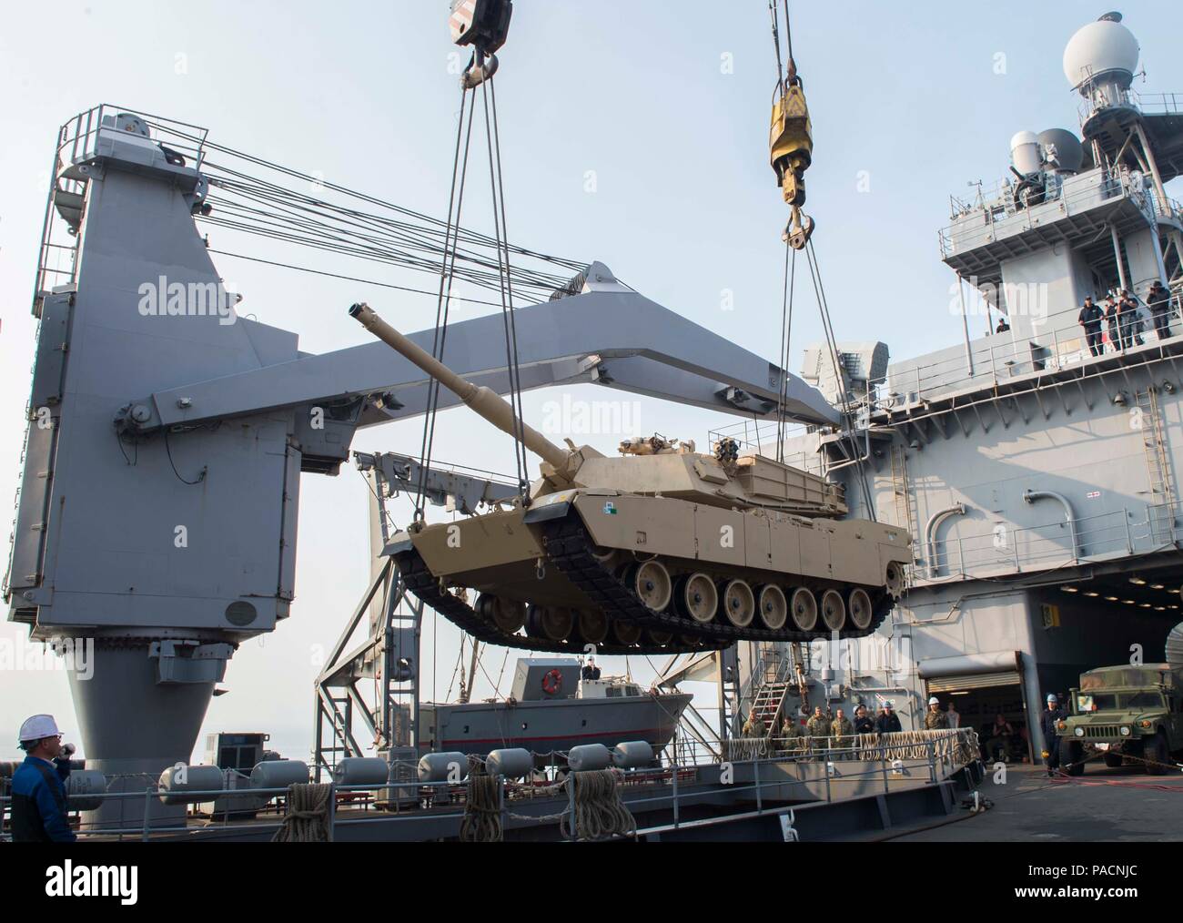 160314-N-RM689-068  GWANGYANG, Republic of Korea (Mar. 14, 2016)- An M1A1 Abram tank attached to Delta Company 1st Tank Battalion, 1st U.S. Marine Division is lowered by two pier side cranes into the well deck of amphibious dock landing ship USS Ashland (LSD 48) to prepare for the Assault Follow-On Echelon (AFOE) portion of Ssang Yong 16. Ashland is assigned to the Bonhomme Richard Expeditionary Strike Group and is participating in Ssang Yong 16, a biennial combined amphibious exercise conducted by forward-deployed U.S. forces with the Republic of Korea Navy and Marine Corps, Australian Army a Stock Photo