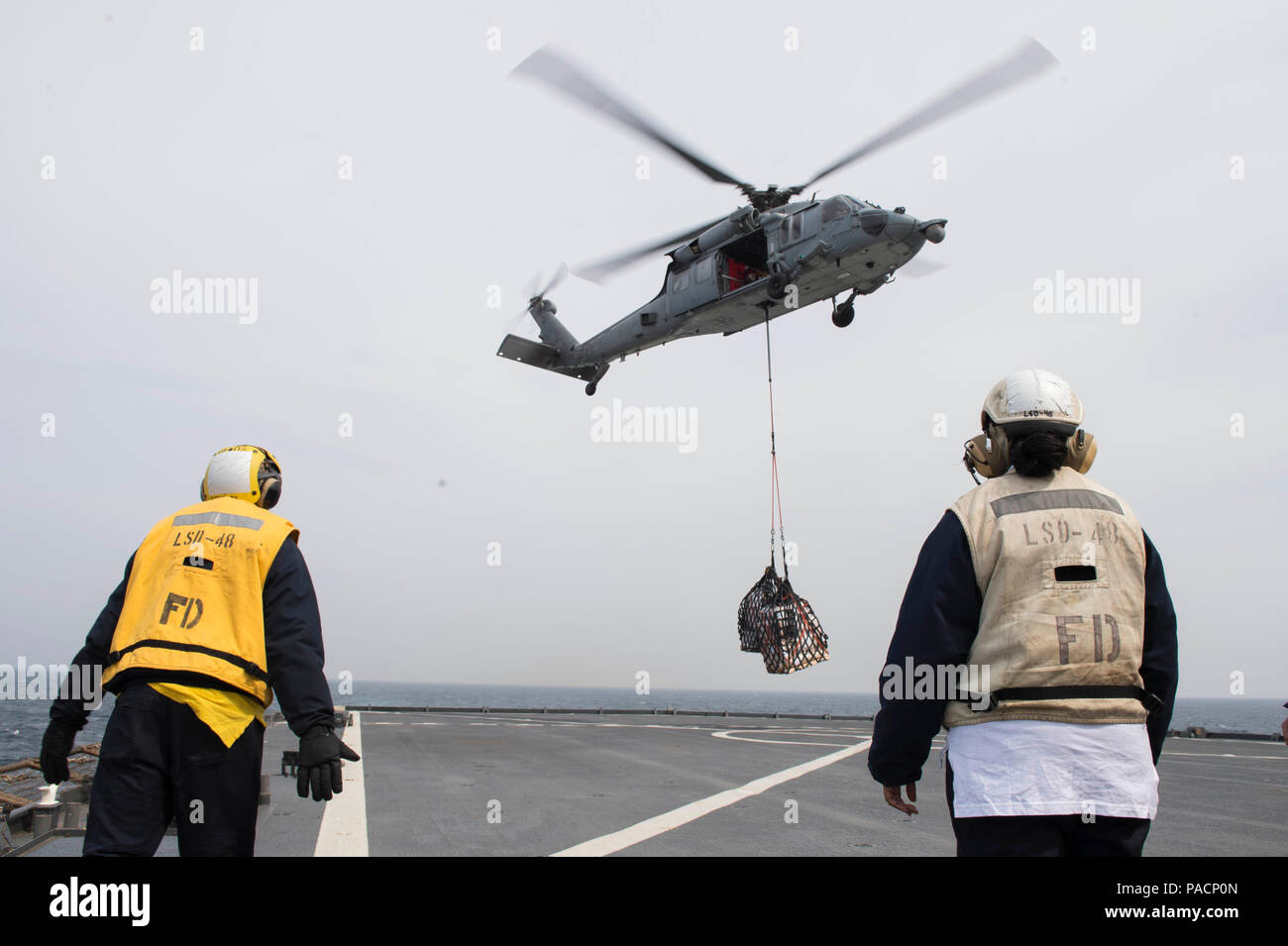 160316-N-RM689-070 EAST SEA (March 16, 2016) - Sailors assigned to amphibious dock landing ship USS Ashland (LSD 48) guide a pallet down onto the flight deck during a vertical replenishment (VERTREP) at sea. Ashland is assigned to the Bonhomme Richard Expeditionary Strike Group and is participating in Ssang Yong 16, a biennial combined amphibious exercise conducted by forward-deployed U.S. forces with the Republic of Korea navy and Marine Corps, Australian army and Royal New Zealand army forces in order to strengthen our interoperability and working relationships across a wide range of militar Stock Photo