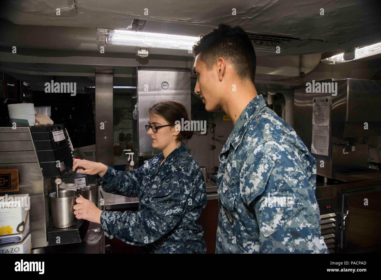 Va. (June 8, 2017) Ship's Serviceman Seaman Brianna Whitman, left, from Kingsford, Mich., teaches Gunner's Mate 3rd Class Adrian Mora, from Modesto, Calif., how to make coffee in the coffeehouse aboard the aircraft carrier USS Dwight D. Eisenhower (CVN 69) (Ike). Ike is pier side during the sustainment phase of the Optimized Fleet Response Plan (OFRP). Stock Photo