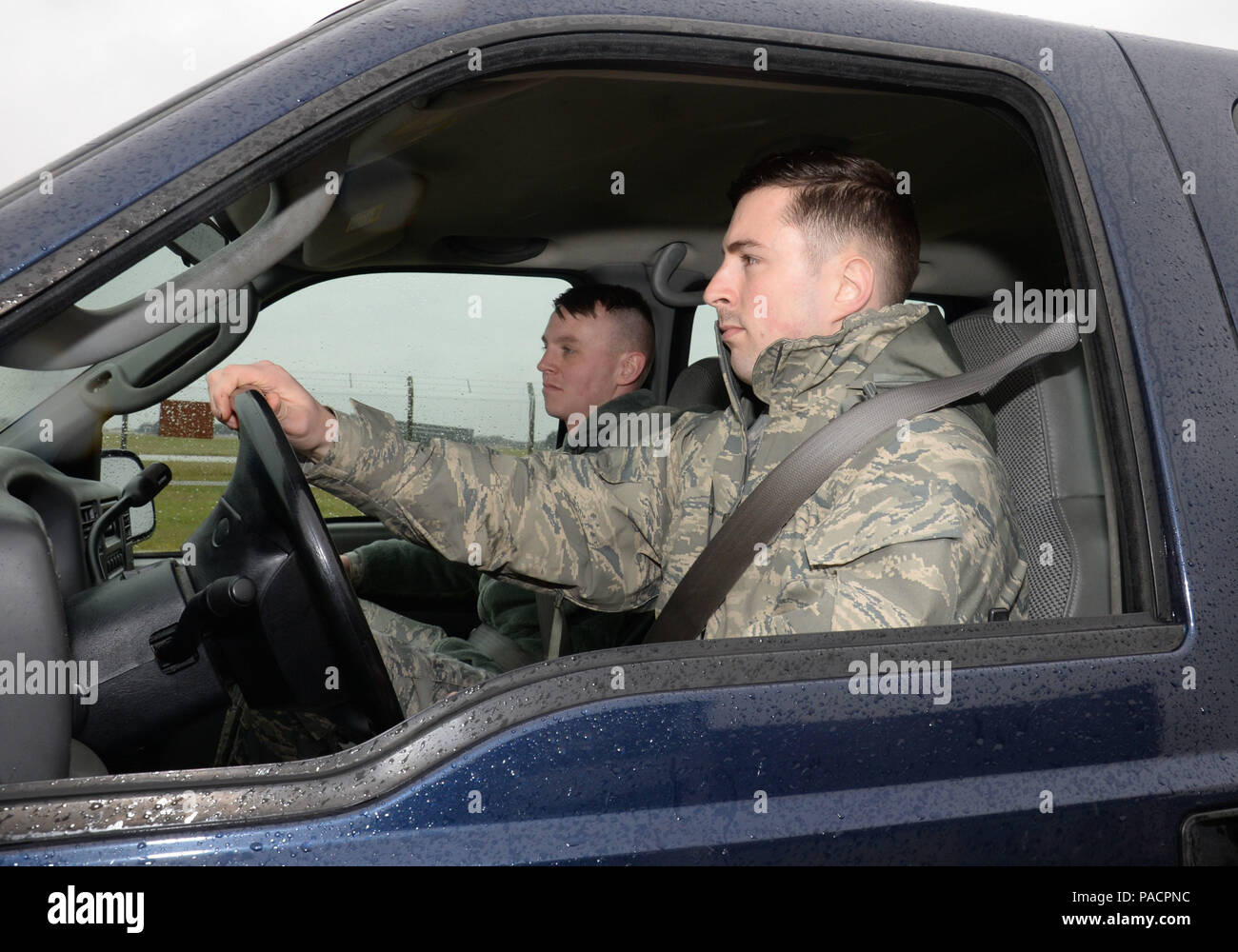 U.S. Air Force Airman 1st Class George Palmer, left, 100th Logistics Readiness Squadron mobile distribution operator, and U.S. Air Force Staff Sgt. Dakota Ferris, 100th LRS NCO in charge of fixed facilities, head to the fuels compound in a government-owned vehicle March 9, 2016, on RAF Mildenhall, England. Fuels facilities are inspected daily, and are spread out across the base. (U.S. Air Force photo by Gina Randall/Released) Stock Photo