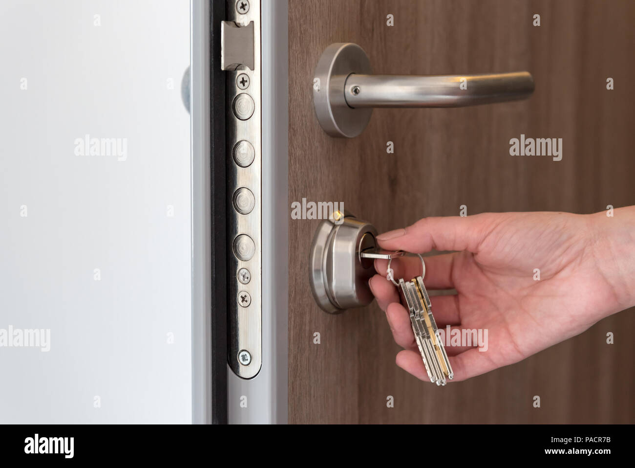 Person using keys and locking apartment door Stock Photo Alamy
