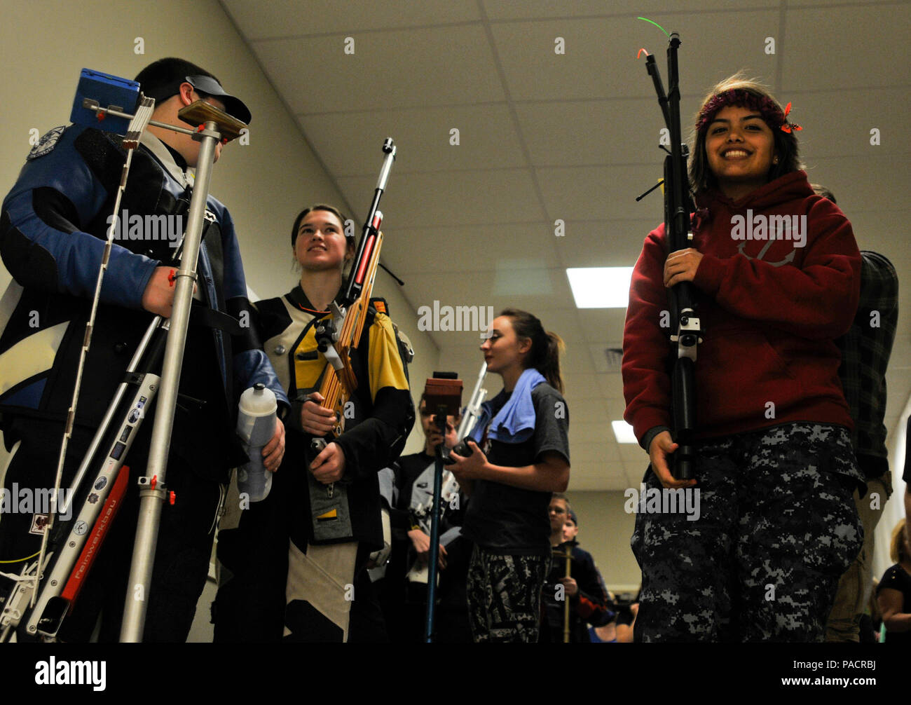 Competitors at the 2016 JROTC National Air Rifle Champions wait to enter the final match in the Sporter class on March 19 in Anniston, Ala. 56 Teams from 73 schools as well as numerous individual shooters representing all four U.S. Armed Forces shot their way through various local and regional competitions in order to qualify for this culminating event. On the right, is Cadet (Navy) Cassandra Rodriguez of Parlier High School in California who would go on to win 1st Place in the Sporter class. Stock Photo