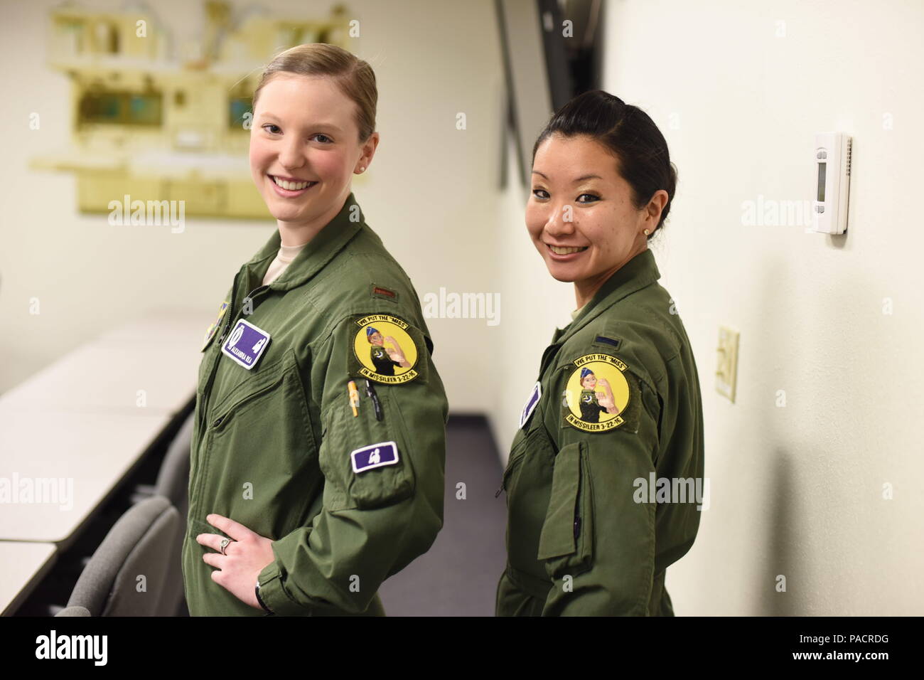 Second Lt. Alexandra Rea, 490th Missile Squadron ICBM combat crew deputy director, left, and 1st Lt. Elizabeth Guidara, 12th Missile Squadron combat crew deputy director, pose for a photograph after a training session at the Building 500 Missile Procedures Trainer March, 21, 2016. During their assignment, the missileers will maintain a 24-hour alert shift to sustain an active alert status of our nation’s intercontinental ballistic missile force. (U.S. Air Force photo/Airman Collin Schmidt) Stock Photo