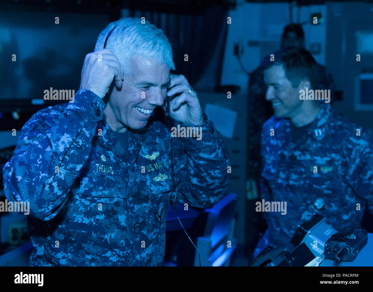160322-N-DI878-053 (March 22, 2016) SAN DIEGO – Capt. Karl Thomas, commanding officer, USS Carl Vinson (CVN 70), wears a headset during a demonstration of the first air traffic control simulator installed on board a Navy aircraft carrier in the USS Carl Vinson air traffic control center (CATCC). Carl Vinson is currently pierside in its homeport of San Diego. (U.S. Navy photo by Mass Communication Specialist 3rd Class Giovanni Squadrito/Released) Stock Photo