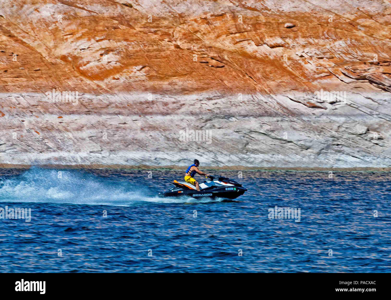 Arizona, USA. 31st May, 2018. A vacationer jet skiing in colorful Antelope Slot Canyon. A narrow, curving, high-walled side arm of Lake Powell, and a favorite tourist attraction, the towering Navajo Sandstone geologically formed walls have red and burnt orange rocks, and are hundreds of feet high. Credit: Arnold Drapkin/ZUMA Wire/Alamy Live News Stock Photo
