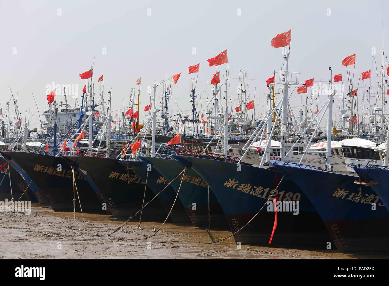 Wenzhou, China's Zhejiang Province. 21st July, 2018. Fishing boats berth on Feiyun River in Rui'an City, east China's Zhejiang Province, July 21, 2018. China's national observatory on Sunday issued a yellow alert for typhoon Ampil which will make landfall in the eastern coastal region around Sunday noon. Credit: Zhuang Yingchang/Xinhua/Alamy Live News Stock Photo