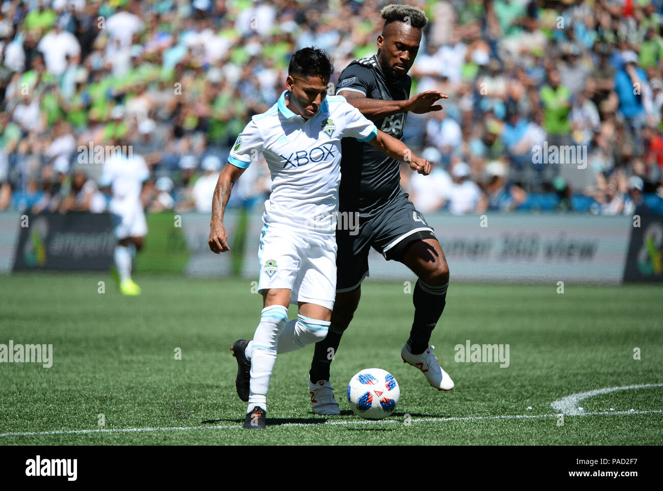 Seattle, Washington, USA. 21st July, 2018. The Whitecaps KENDALL WASTON (4) defends against recently signed RAUL RUIDIAZ (9) as the Vancouver Whitecaps visit the Seattle Sounders for an MLS match at Century Link Field in Seattle, WA. Credit: Jeff Halstead/ZUMA Wire/Alamy Live News Stock Photo