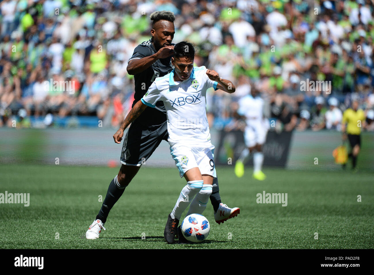 Seattle, Washington, USA. 21st July, 2018. The Whitecaps KENDALL WASTON (4) defends against recently signed RAUL RUIDIAZ (9) as the Vancouver Whitecaps visit the Seattle Sounders for an MLS match at Century Link Field in Seattle, WA. Credit: Jeff Halstead/ZUMA Wire/Alamy Live News Stock Photo