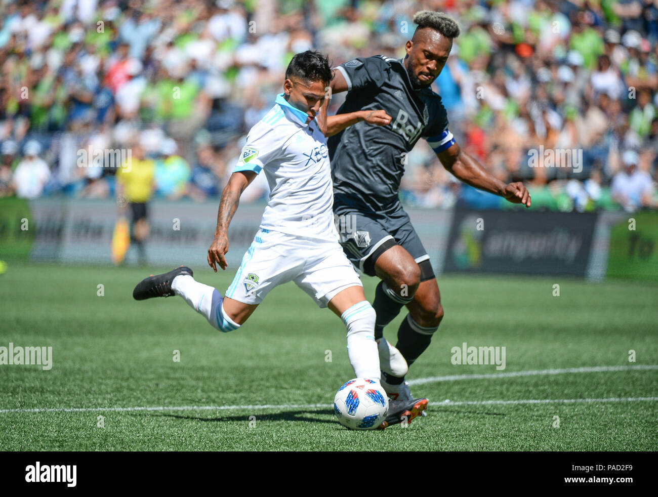 Seattle, Washington, USA. 21st July, 2018. RAUL RUIDIAZ (9) takes a shot against the defense of KENDALL WASTON (4) as the Vancouver Whitecaps visit the Seattle Sounders for an MLS match at Century Link Field in Seattle, WA. Credit: Jeff Halstead/ZUMA Wire/Alamy Live News Stock Photo
