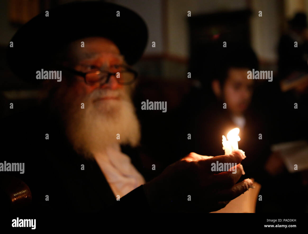 Jerusalem. 21st July, 2018. Ultra-Orthodox Jewish men use candles to read from the book of Eicha (Book of Lamentations) during the annual Tisha B'Av (Ninth of Av) fasting and a memorial day in the Ultra-Orthodox neighborhood of Mea Shearim in Jerusalem, on July 21, 2018. Credit: Gil Cohen Magen/Xinhua/Alamy Live News Stock Photo