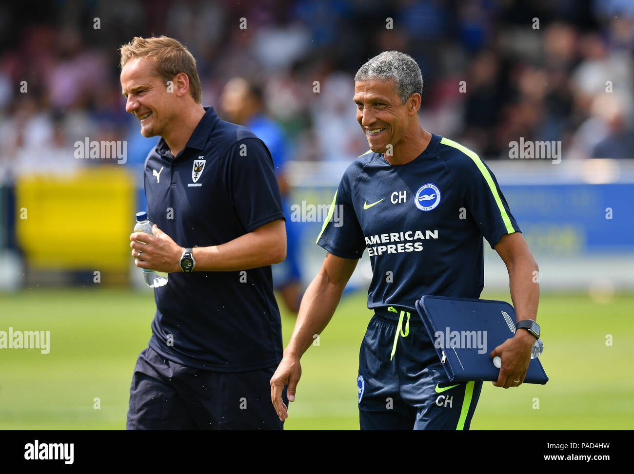 London, UK. 21st July, 2018: Brighton & Hove Albion Manager Chris Hughton walks out onto the pitch with AFC Wimbledon Manager Neil Ardley before the Pre-Season Friendly at the Cherry Red Records Stadium, London, UK. Credit:Ashley Western/Alamy Live News Stock Photo