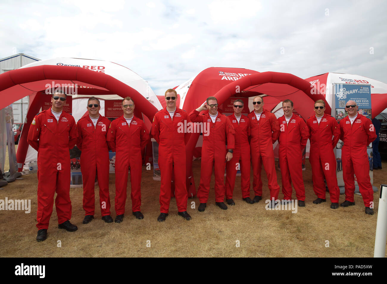 Farnborough, UK. 22 July 2018.On it’s last day, Farnborough International Airshow 2018 hosts the ever popular Red Arrows. The pilots posed for a group photo with an on duty Paramedic and her bike. Credit: Keith Larby/Alamy Live News Stock Photo