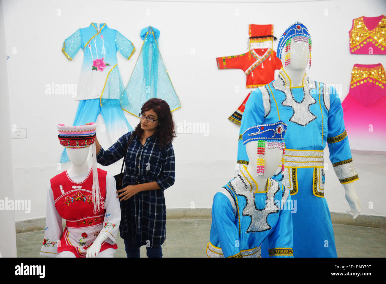 Dhaka. 22nd July, 2018. A visitor touches the costume at the exhibition portraying the history and culture of the ancient Silk Road in Zainul Gallery of the Faculty of Fine Arts of Dhaka University (DU) in Dhaka, Bangladesh, on July 22, 2018. Credit: Xinhua/Alamy Live News Stock Photo