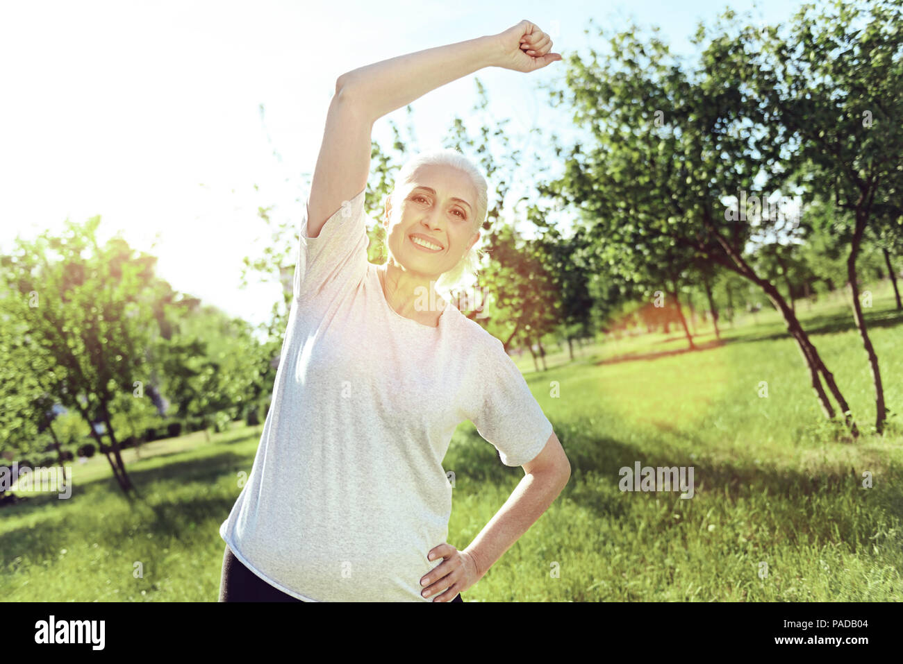 Energetic positive pensioner doing useful exercises Stock Photo