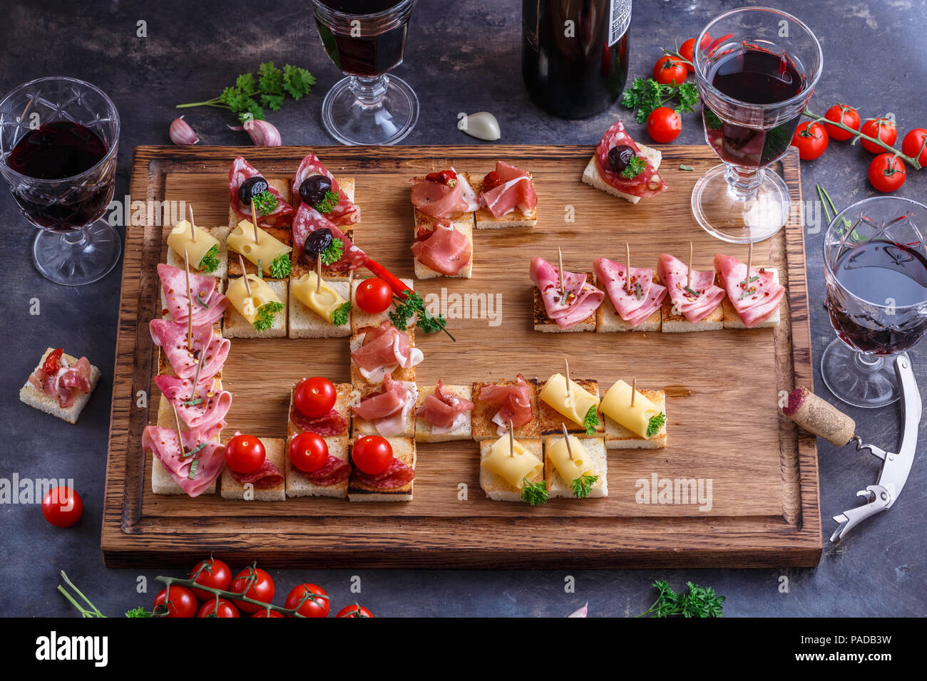 Brushetta or authentic traditional spanish tapas set for lunch table.  Sharing antipasti on party or summer picnic time over blue rustic  background. Top view, flat lay Stock Photo - Alamy
