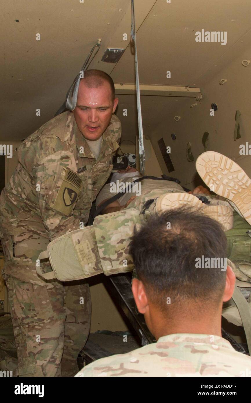Sgt. Charles Duvall, the senior medic with Battery A, 4th Battalion, 3rd Air Defense Artillery, helps load patients into an M997 Field Litter Ambulance during a force protection and mass casualty training exercise in Kuwait, March 26, 2016. The training aimed at preparing the Soldiers for potential real-world conflicts. (U.S. Army photo by Sgt. David N. Beckstrom, 19th Public Affairs Detachment, U.S. Army Central) Stock Photo