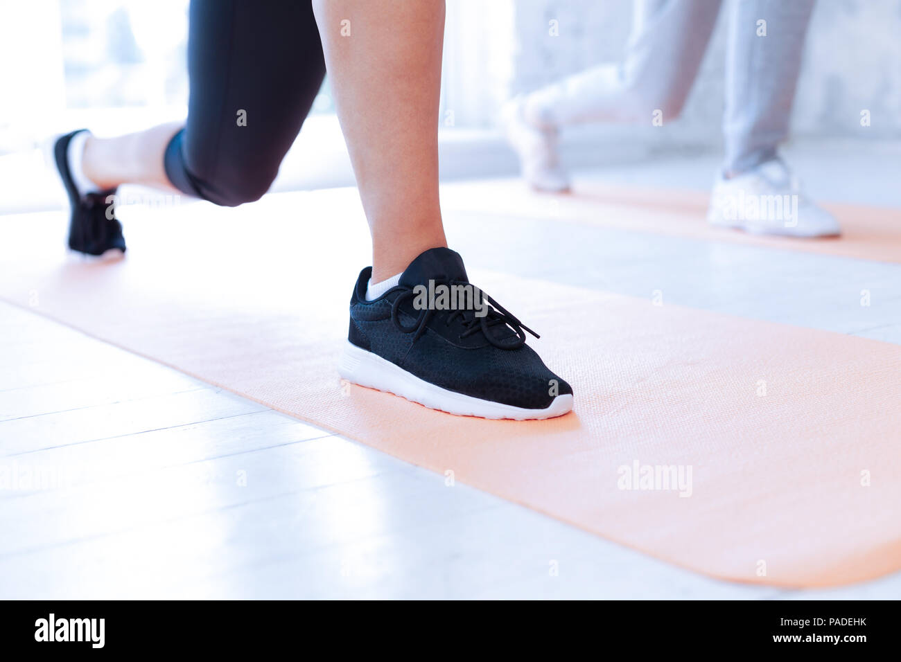 Focused photo on female feet that wearing sneakers Stock Photo