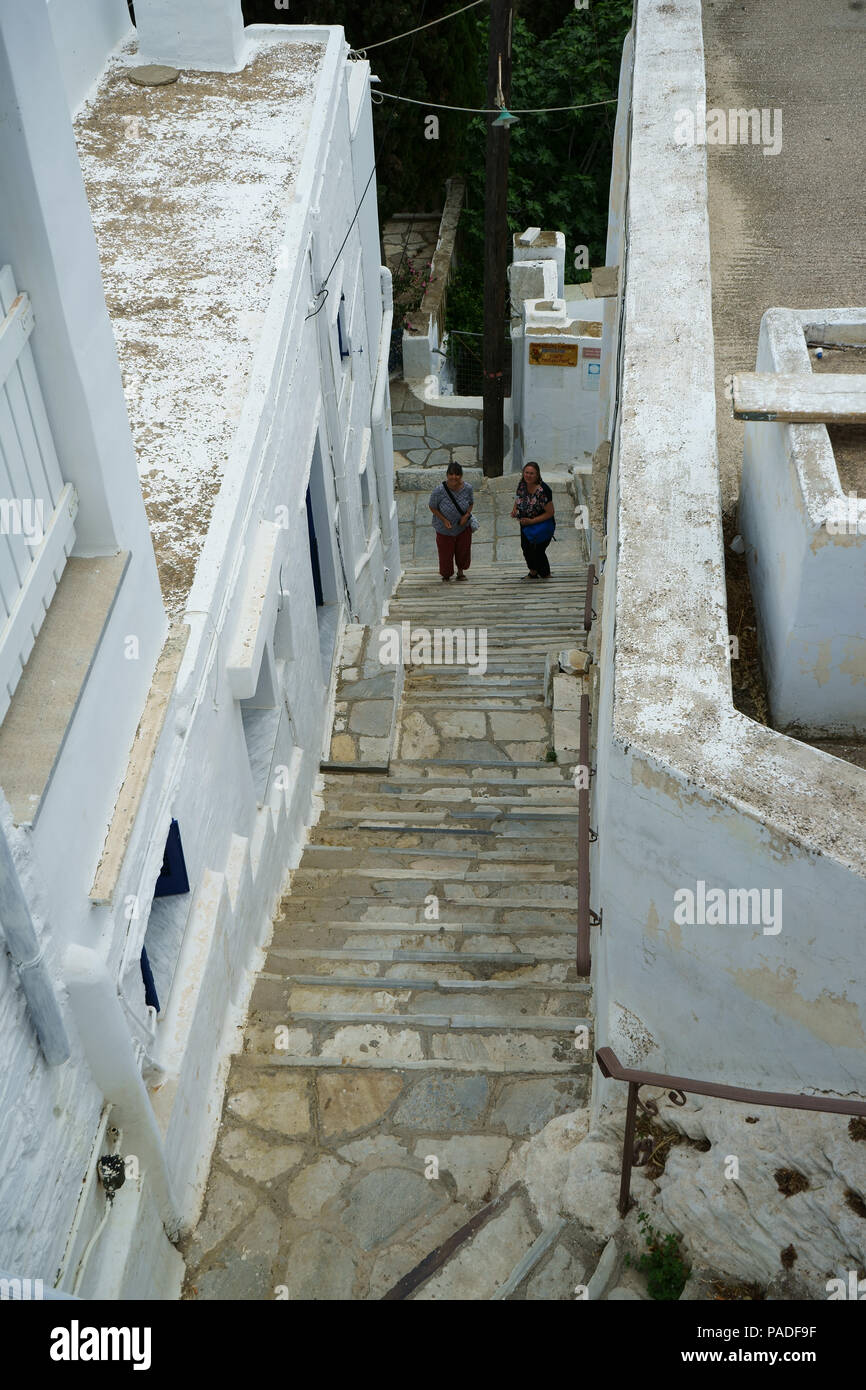 Visitors at bottom of steep marble stair, town Kardiani, Island Tinos, Cyclades, Greece Stock Photo