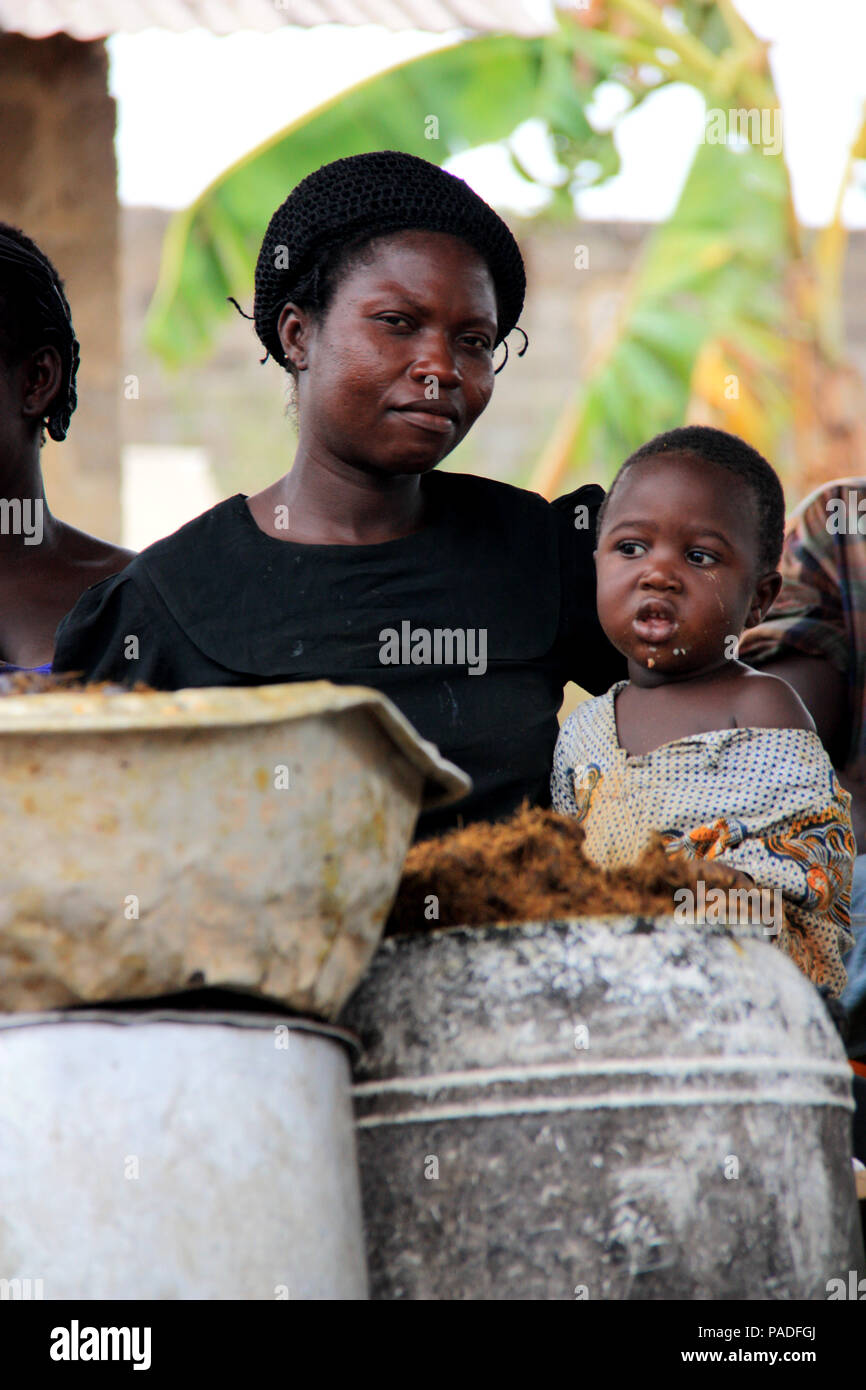 African woman and her baby at a palm oil factory near Cape Coast, Ghana Stock Photo