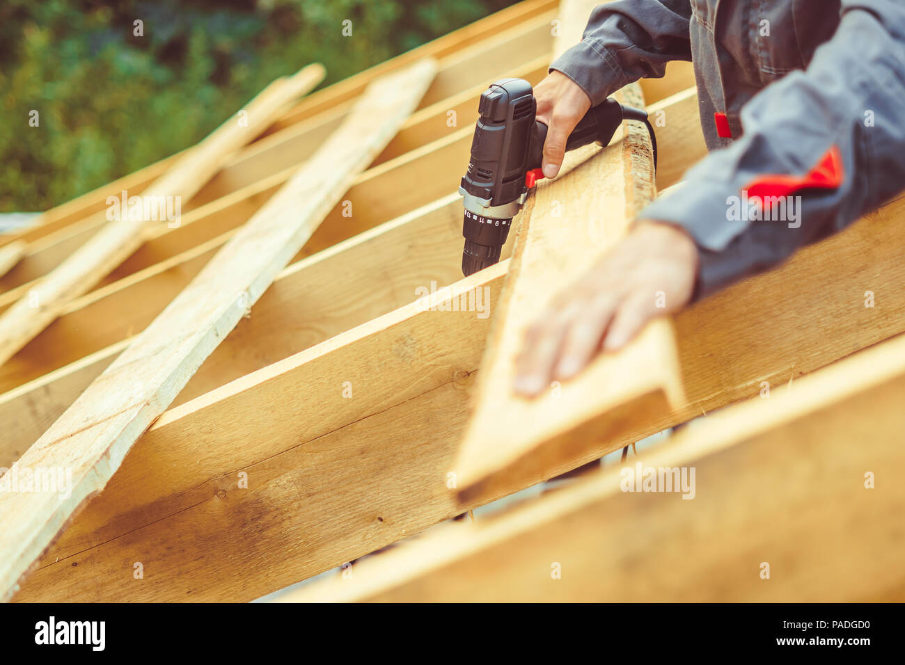 worker roofer builder working on roof structure on construction site