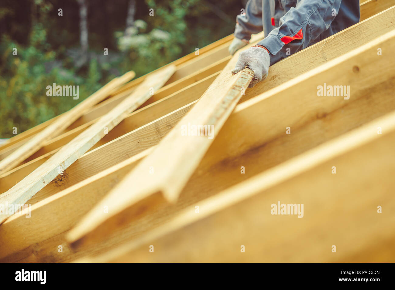 worker roofer builder working on roof structure on construction site